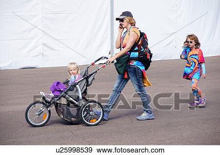 Stock Photo -  albq balloon fiesta candid mother two daughters. Fotosearch