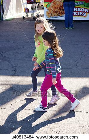 Picture -  albq balloon fiesta girl children kids walking. Fotosearch