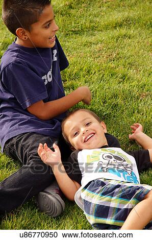 Stock Image -  albq balloon fiesta latino hispanic boys laying. Fotosearch