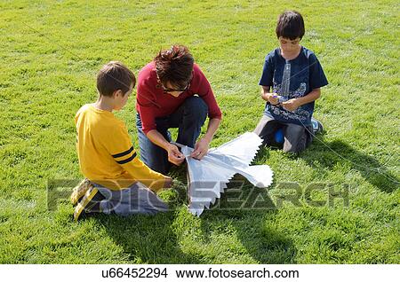 albq balloon fiesta mother showing boys fly kite View Large Photo Image Picture - albq balloon fiesta mother showing boys fly kite. Fotosearch