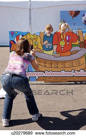 Stock Photo -  albq balloon fiesta mother taking pictures kids. Fotosearch