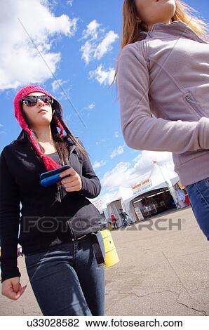 Stock Image -  albq balloon fiesta teen teenager girls walking. Fotosearch