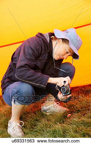 Stock Image -  albq balloon fiesta woman female taking camera. Fotosearch