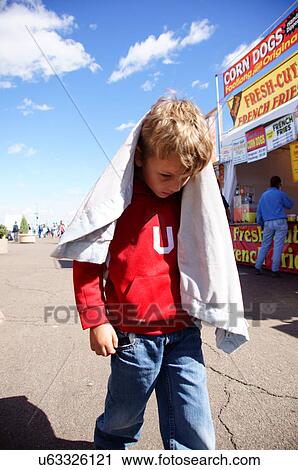 Stock Image -  albq balloon fiesta youn boy child kid head down. Fotosearch
