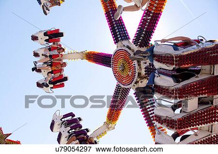 Stock Photo -  amusement park ride aerial toss turn boys girls. Fotosearch