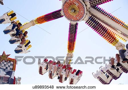 Stock Photo -  amusement park ride aerial toss turn boys girls. Fotosearch