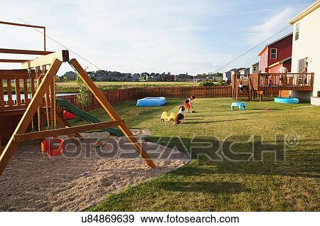 backyard playground kids dogs urban suburb swing View Large Photo Image Stock Photo - backyard playground kids dogs urban suburb swing. Fotosearch