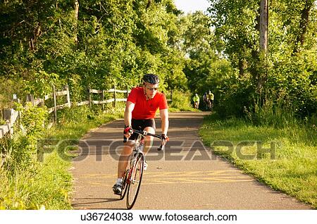 biker bicyclist cyclist path woods exercise fort View Large Photo Image Stock Photo - biker bicyclist cyclist path woods exercise fort. Fotosearch