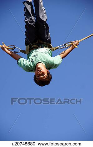Stock Image -  boy child kid doing somersault on swing rope. Fotosearch