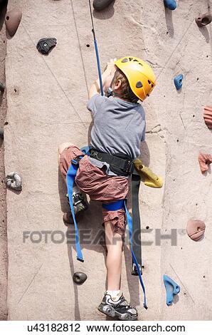 Stock Image -  boy child kid rock climbing indoor sport kids. Fotosearch