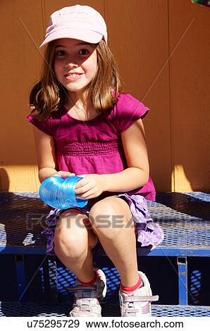 Stock Photo -  brunette caucasian white girl child kid with hat. Fotosearch