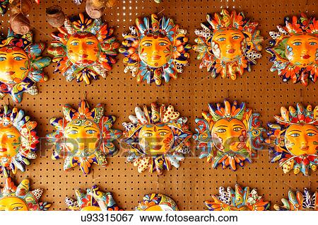 Stock Photo -  ceramic face plaques sun shine taos new mexico. Fotosearch