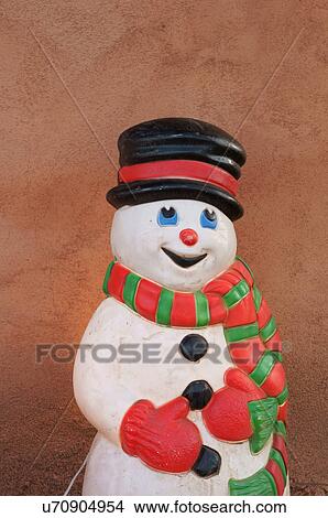 Picture -  ceramic snowman in front of adobe new mexico nm. Fotosearch