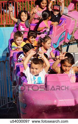 Stock Photo -  children kids girls boys raising hands on roller. Fotosearch