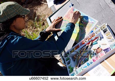 Stock Image -  closeup of artist hands drawing scenic female. Fotosearch