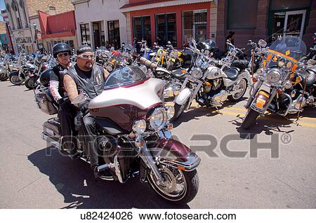 Stock Photograph -  couple man male person riding street motorcycle. Fotosearch