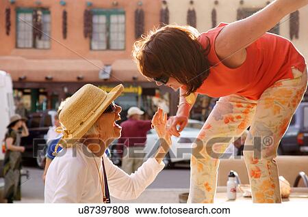 elderly woman female and young talking laughing View Large Photo Image Stock Photo - elderly woman female and young talking laughing. Fotosearch