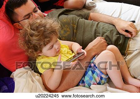 Stock Photography -  father children kids reading girl man male kid. Fotosearch