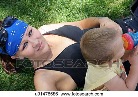 Stock Photograph -  female child kid mother smile boy male las. Fotosearch