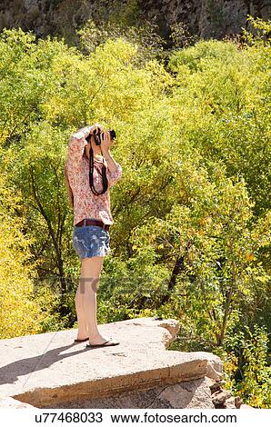 female taking picture in woods outdoors adult View Large Photo Image Stock Image - female taking picture in woods outdoors adult. Fotosearch