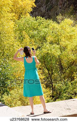female taking picture in woods outdoors adult View Large Photo Image Stock Photo - female taking picture in woods outdoors adult. Fotosearch