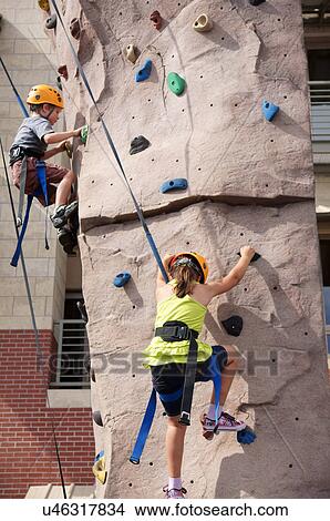 Picture -  girl boy child kid rock climbing indoor sport. Fotosearch