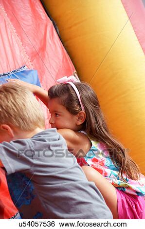 girl boy inflatable bounce house child kid sport View Large Photo Image Stock Photograph - girl boy inflatable bounce house child kid sport. Fotosearch