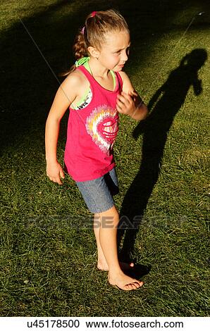 Stock Image -  girl child kid female doing shadow pantomime on. Fotosearch