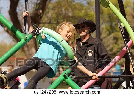 Stock Photo -  girl child kid gyroscope game play carnival las. Fotosearch
