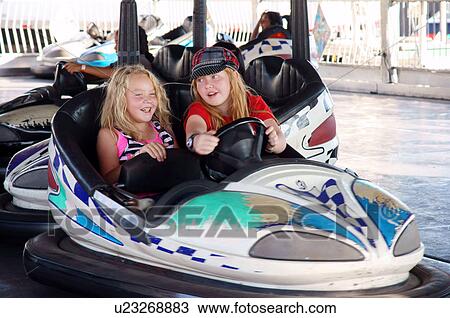 Stock Image -  girls in bumber car ride laughing friends kids. Fotosearch