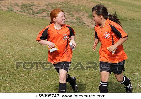 Stock Photo -  girls run running sequence lvysl soccer ball kid. Fotosearch