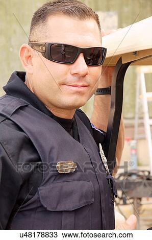 Stock Image -  latino hispanic cop policeman officer portrait. Fotosearch