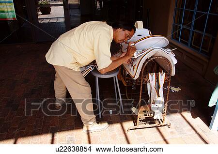 latino hispanic man male detailing horse saddle View Large Photo Image Picture - latino hispanic man male detailing horse saddle. Fotosearch