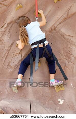 Picture -  little girl child kid rock climbing climb skill. Fotosearch