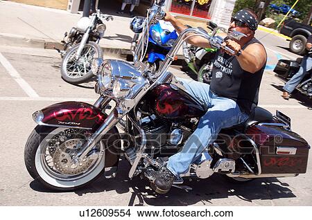 Picture -  man male ride motorcycle street rally july 27-29. Fotosearch