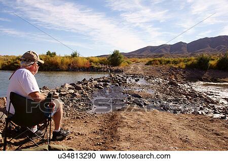 Stock Image -  man male senior citizen aged sitting at rio. Fotosearch