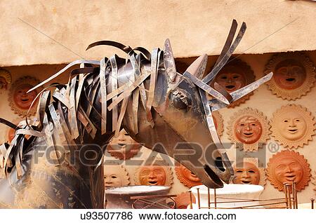 Stock Photograph -  metal horse and ceramic plates taos new mexico. Fotosearch
