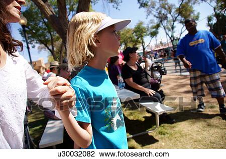 Stock Image -  mother and daughter holding hands outdoors fear. Fotosearch