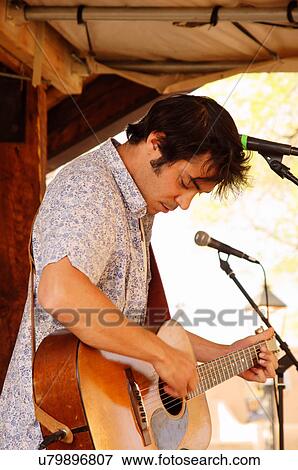 Stock Photo -  musician max gomez performing stage taos new nm. Fotosearch