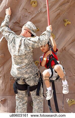 national guard soldier helping little boy child View Large Photo Image Stock Image - national guard soldier helping little boy child. Fotosearch