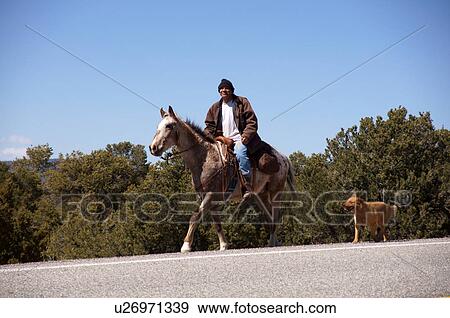 Stock Photo -  native american on horse dog questa nm adult. Fotosearch