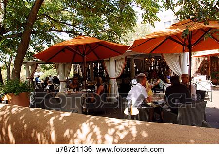 Stock Photograph -  people enjoying food at the lumineria restaurant. Fotosearch