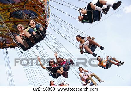 people on carnival ride chair wheel chain happy View Large Photo Image Stock Photo - people on carnival ride chair wheel chain happy. Fotosearch