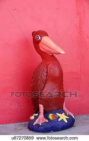 Stock Photo -  red pelican statue dragon inn at truth or new. Fotosearch