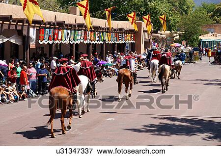 Stock Photo -  santa fe nm crowd watching parade horses spanish. Fotosearch