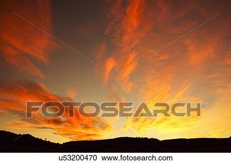 Stock Image -  saturated sunset new mexico nm sun hills light. Fotosearch
