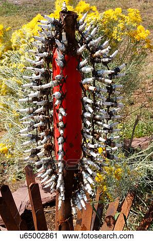 Stock Image -  sculpture made of spark plugs and muffler art. Fotosearch