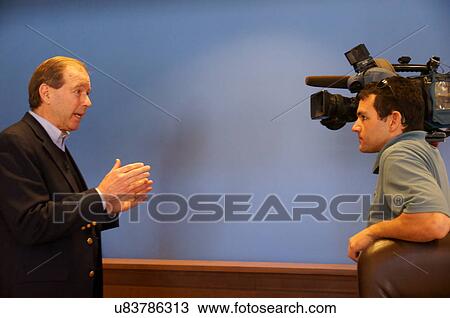Stock Image -  senator tom udall nm being tv reporter camera. Fotosearch