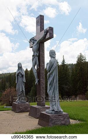 Stock Photography -  statue christ jesus cross cemetary lead south sd. Fotosearch