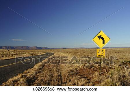 Stock Photo -  sun 45 mph curve sign reflecting new nm mexico. Fotosearch